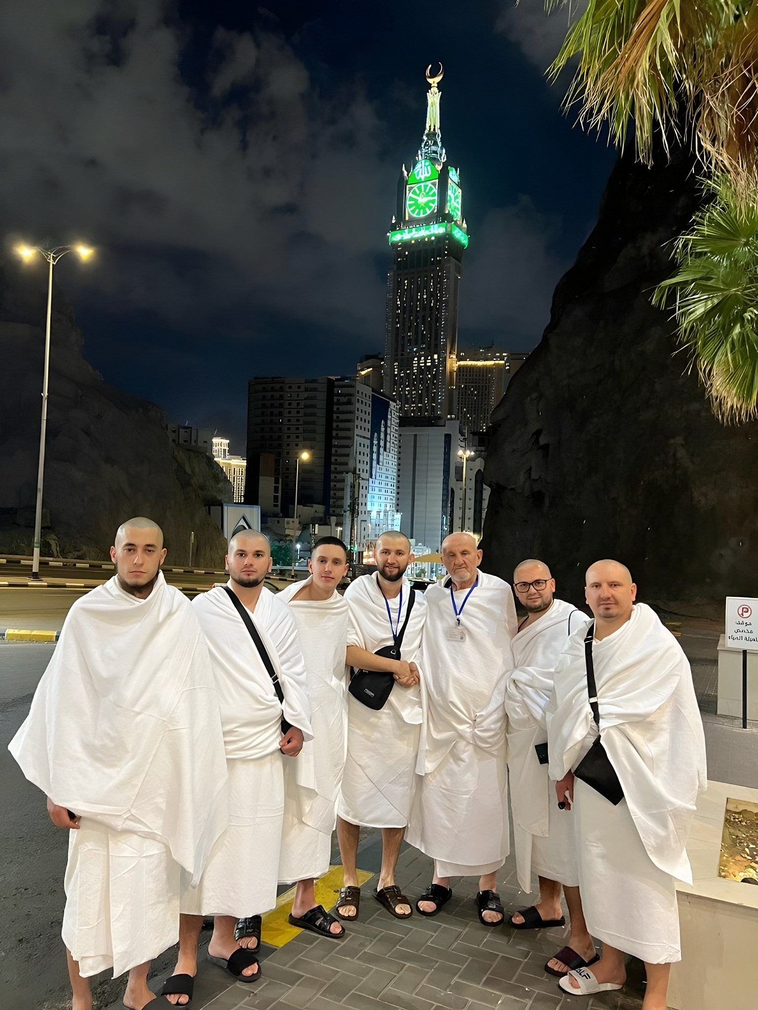 Haxhinjtë e Hixhaz Tours me ihram para Kullës së Sahatit në Mekë natën